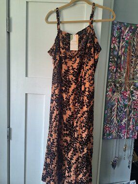 Nwt xxl This dress is a sleeveless spaghetti strap midi dress with a black flor